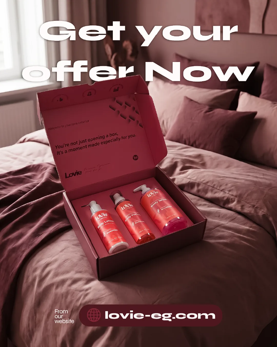 Portrait static headlined Get your offer now: the open Lovie gift box holding the red trio on rumpled bed linen.