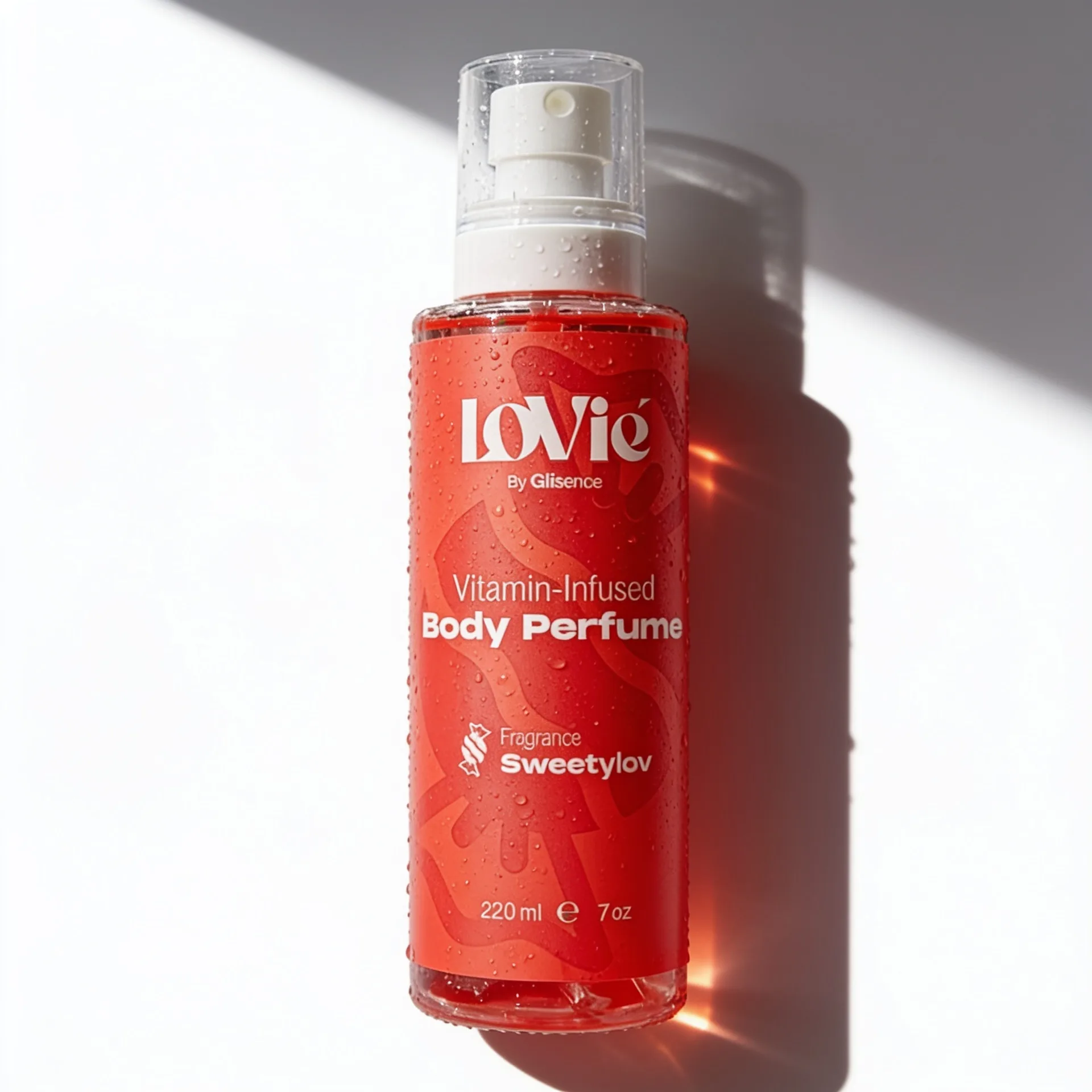 The red Sweetylov body perfume standing in raking sunlight against a pale wall.