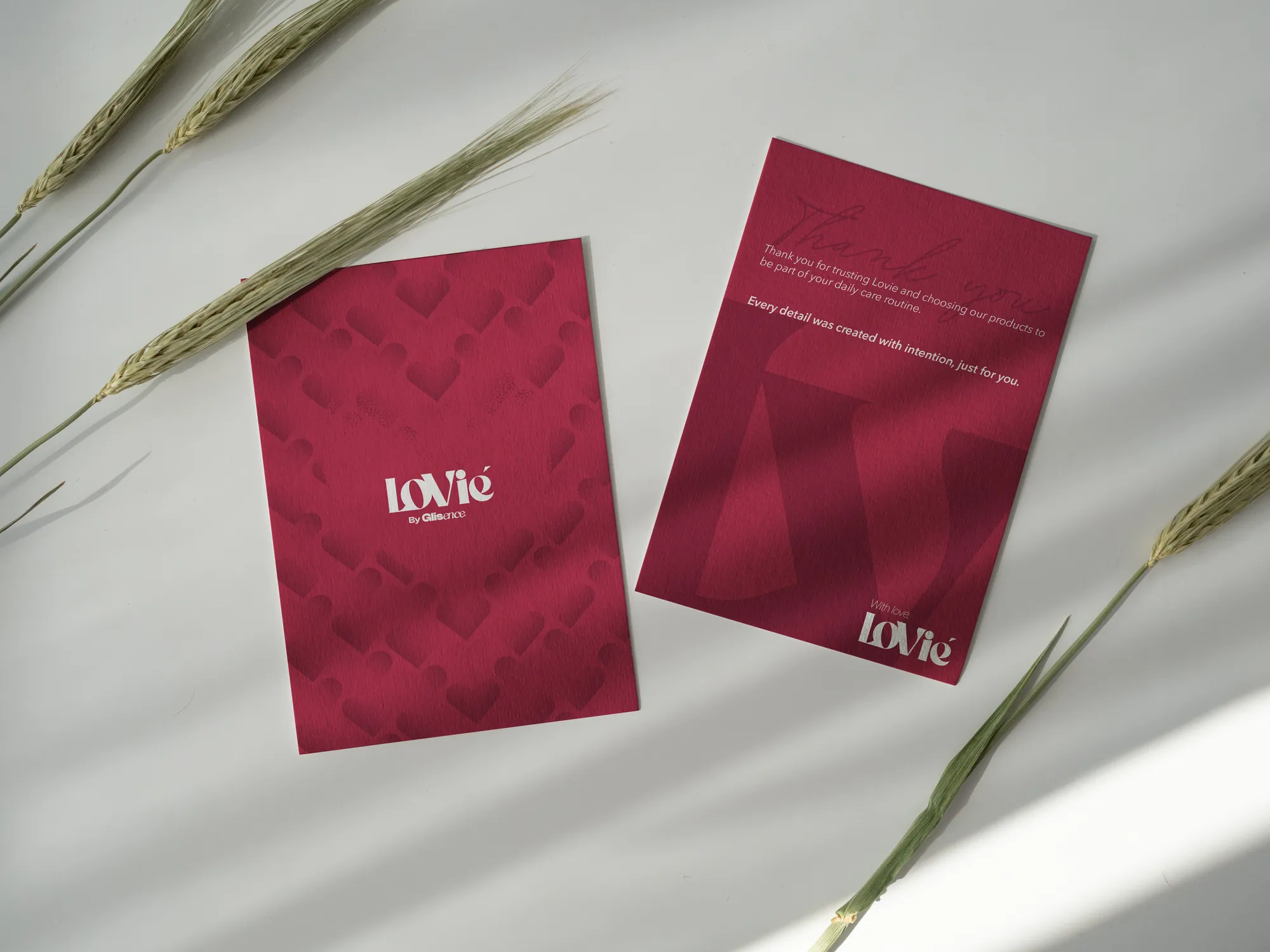 Two printed Lovie thank-you cards photographed with dried wheat stems.