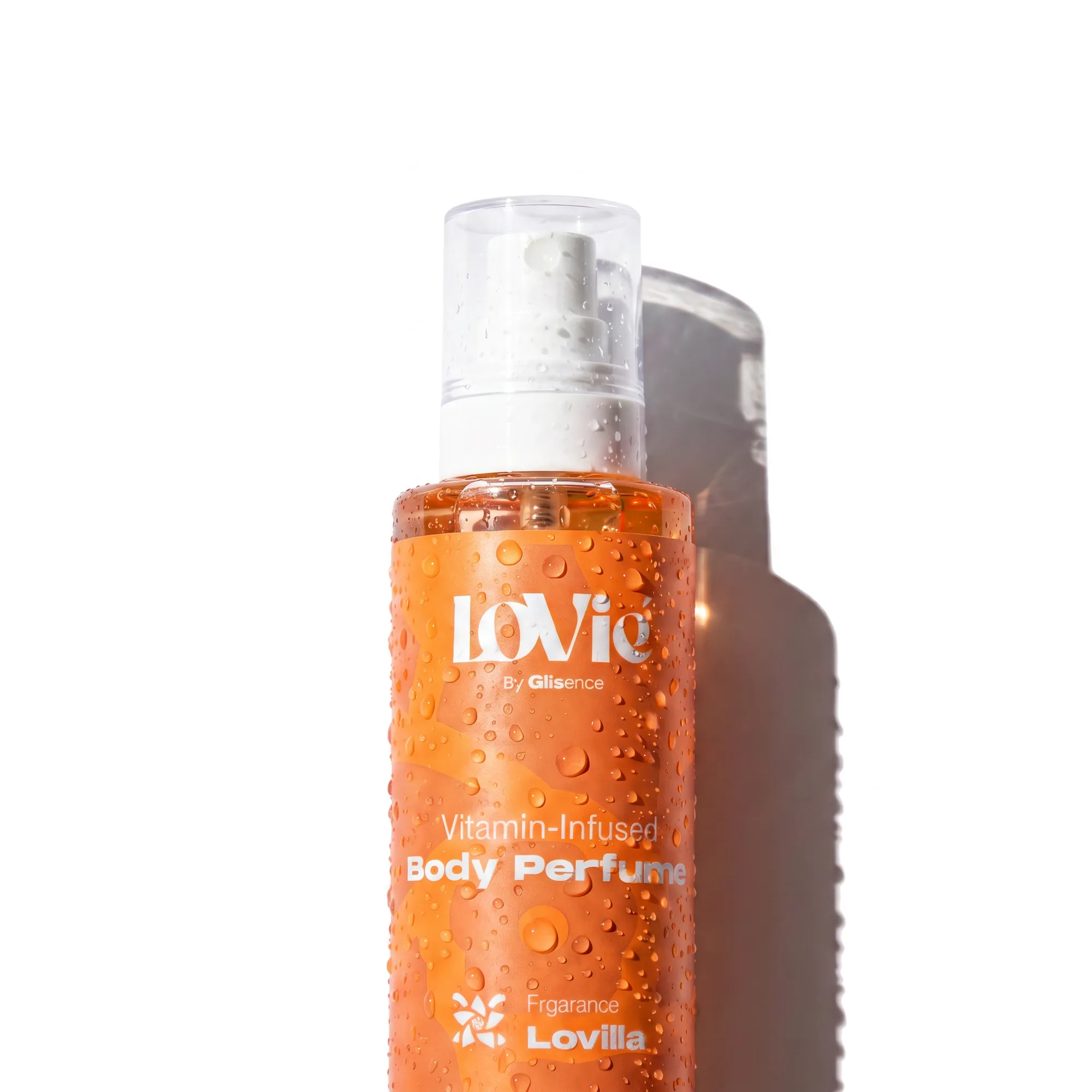 Orange Lovie body perfume bottle beaded with water droplets against a white ground.